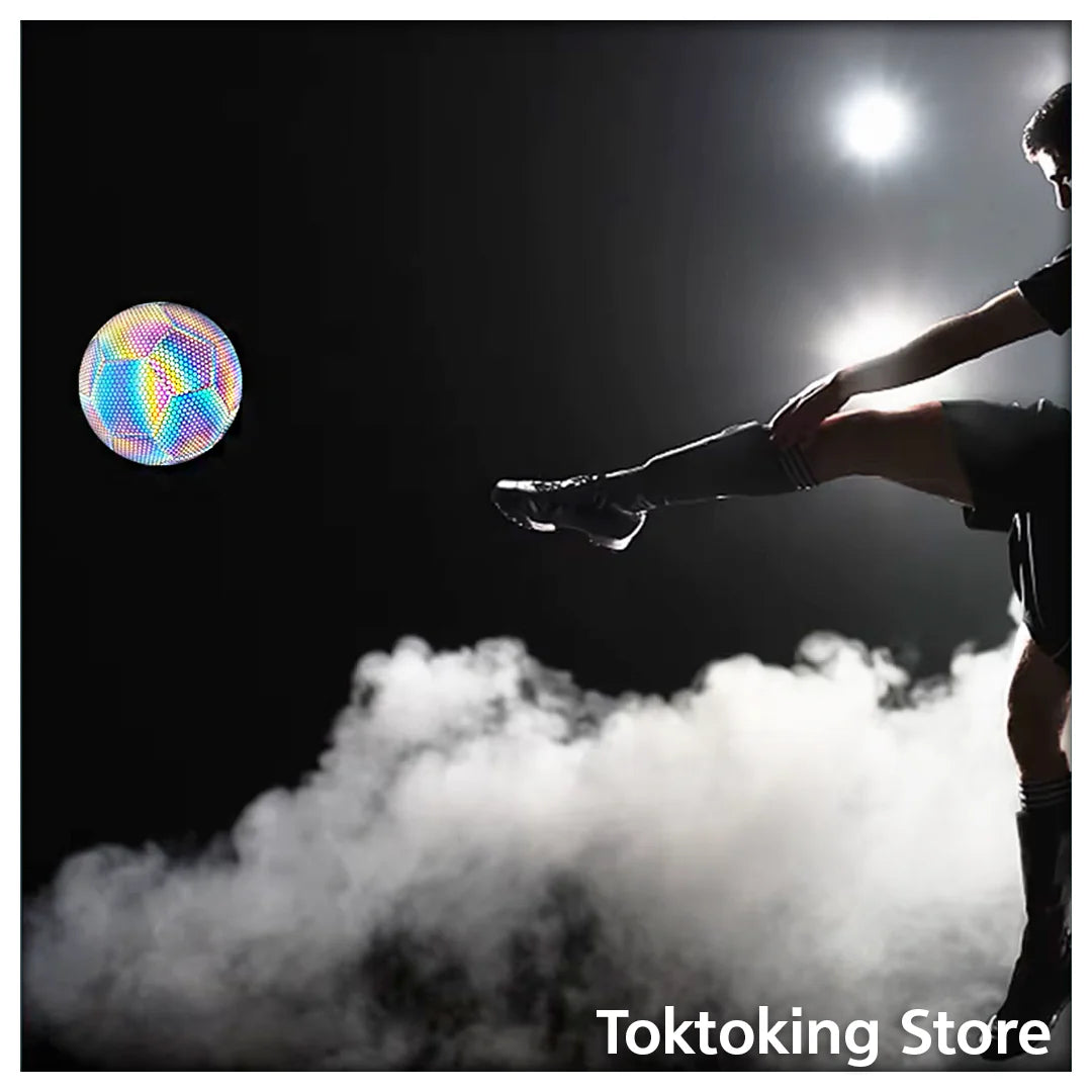 Reflective soccer ball glowing brightly at night showing high-visibility luminous panels for outdoor training