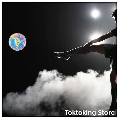 Reflective soccer ball glowing brightly at night showing high-visibility luminous panels for outdoor training